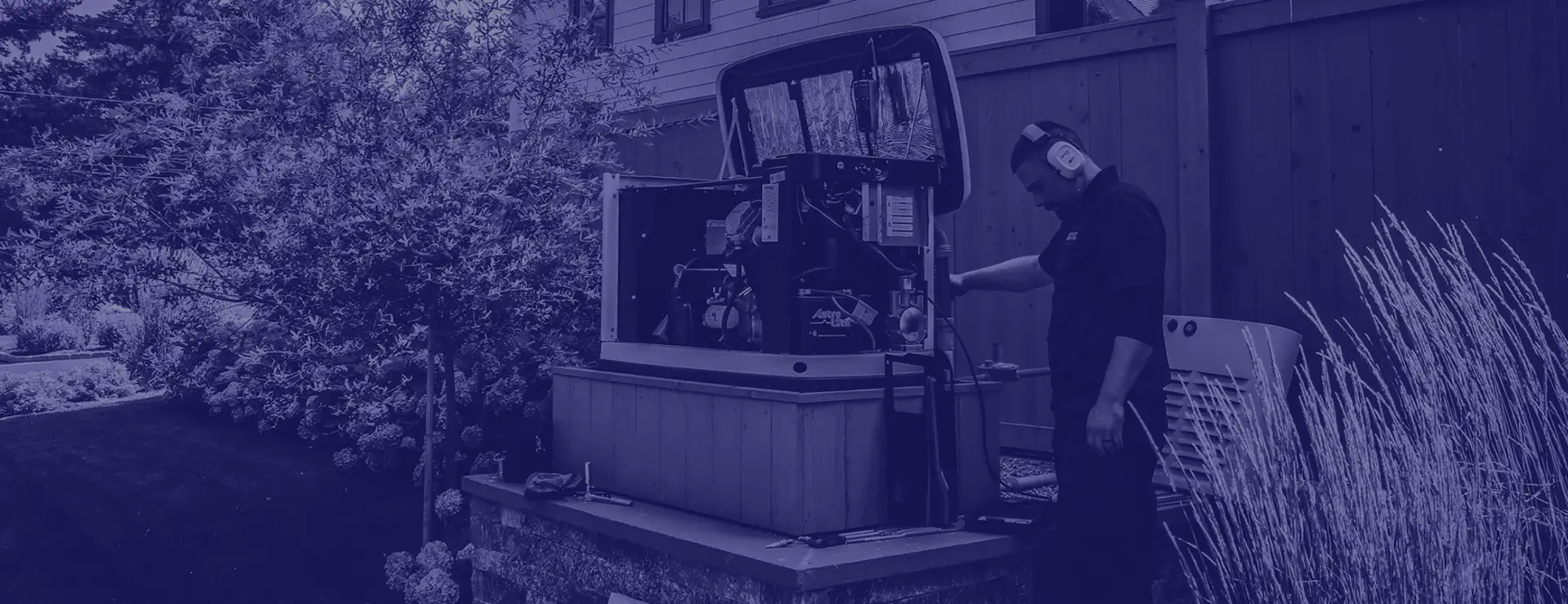Technician providing generator maintenance with blue color overlay